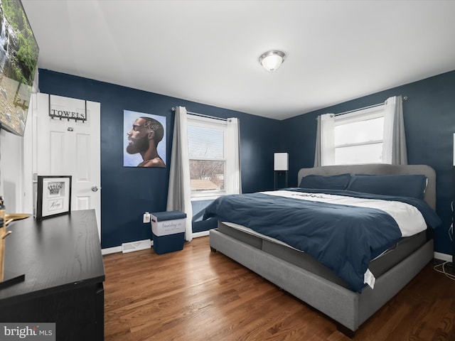 bedroom featuring baseboards and wood finished floors