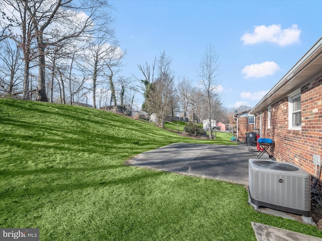 view of yard with a patio area and central air condition unit