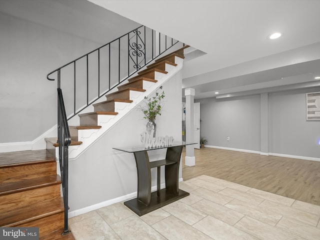 staircase with recessed lighting, baseboards, and wood finished floors