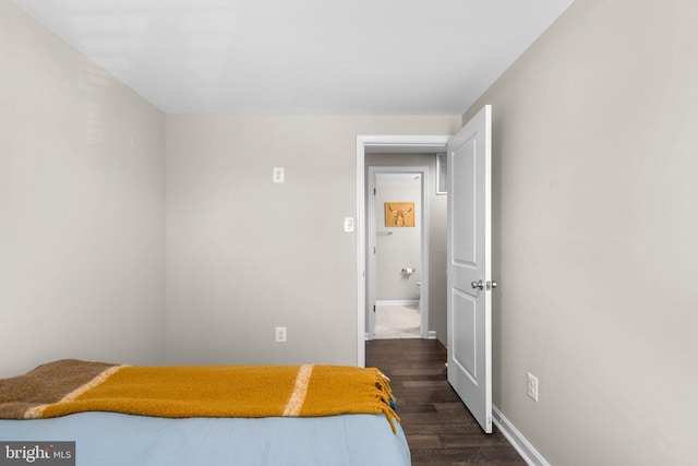 bedroom with baseboards and dark wood-style floors