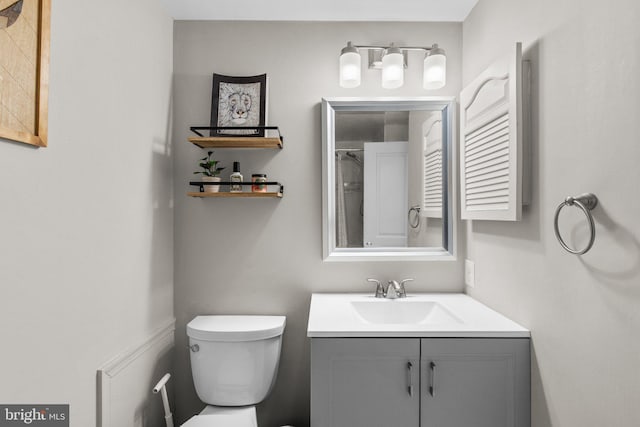 bathroom featuring toilet and vanity