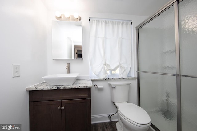 full bath featuring toilet, wood finished floors, visible vents, vanity, and a stall shower