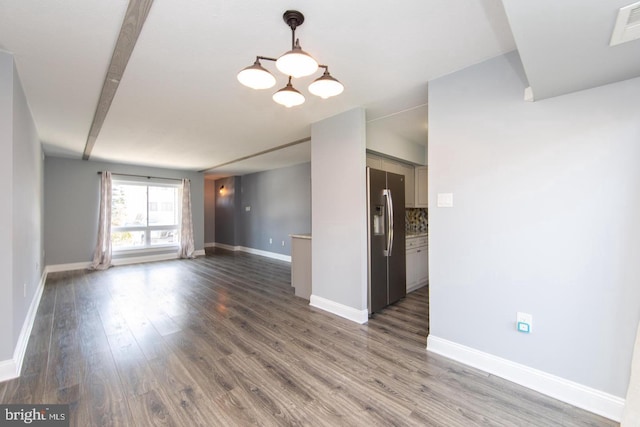 interior space with visible vents, baseboards, and wood finished floors