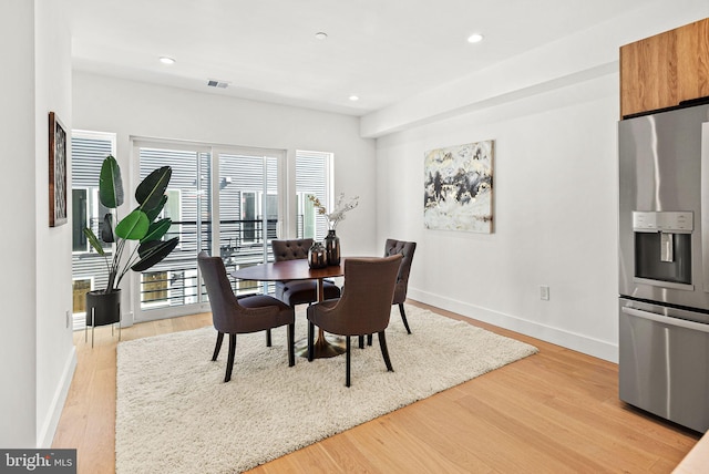 dining room featuring light wood-style flooring, recessed lighting, visible vents, and baseboards