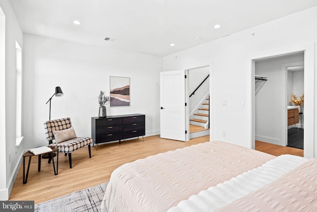 bedroom with recessed lighting, baseboards, a spacious closet, and light wood finished floors