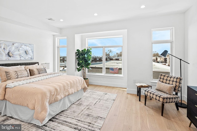 bedroom with recessed lighting, multiple windows, visible vents, and light wood-type flooring