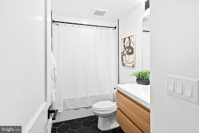 bathroom with vanity, visible vents, shower / bath combo, tile patterned floors, and toilet