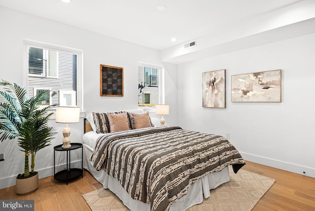 bedroom featuring visible vents, recessed lighting, wood finished floors, and baseboards