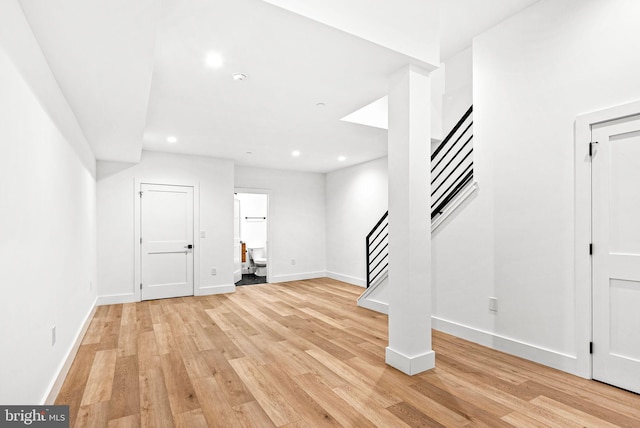 entrance foyer with stairway, recessed lighting, baseboards, and light wood finished floors