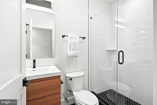 full bath with a shower stall, toilet, and vanity