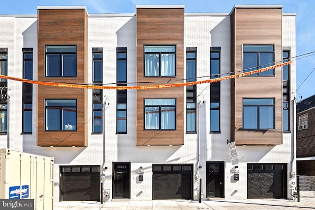 exterior space featuring an attached garage and fence