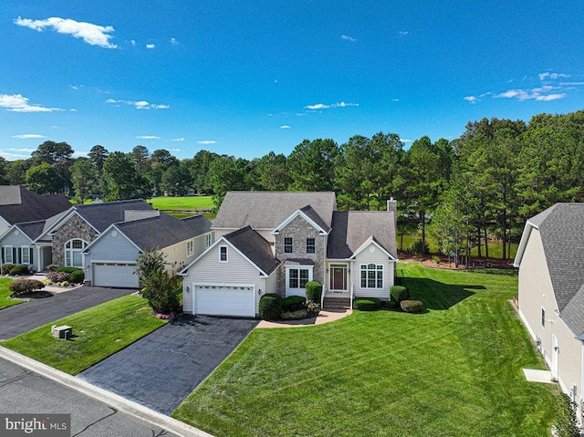 traditional-style home featuring a shingled roof, stone siding, a chimney, aphalt driveway, and a front lawn