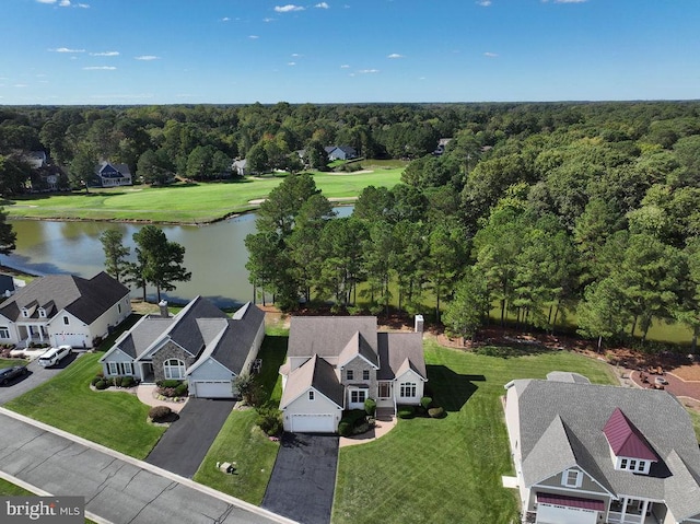 drone / aerial view featuring a water view, a forest view, and a residential view