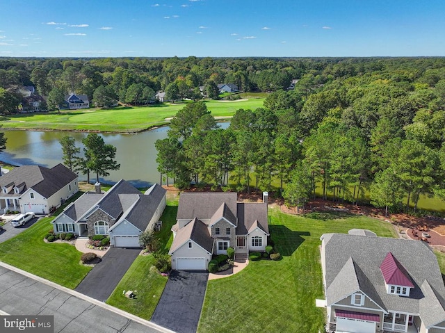 drone / aerial view featuring a water view, a forest view, and a residential view