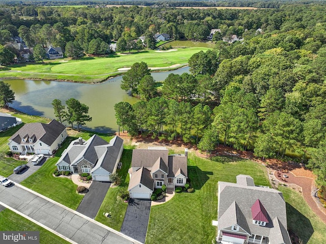 birds eye view of property with a water view, a wooded view, and a residential view