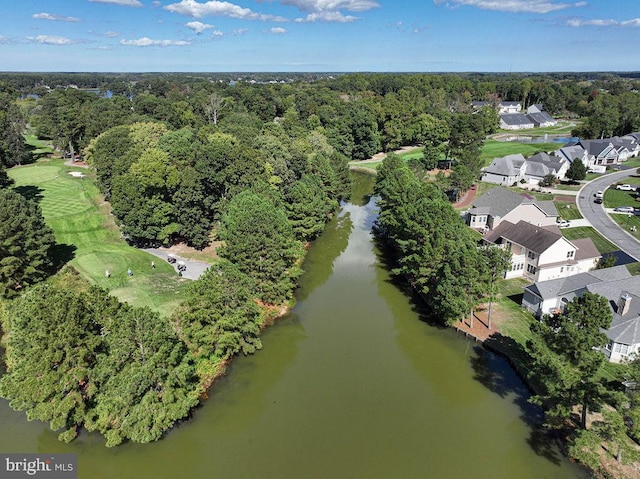 drone / aerial view with a water view, a wooded view, and a residential view