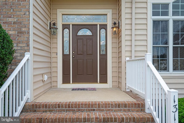 view of exterior entry featuring brick siding