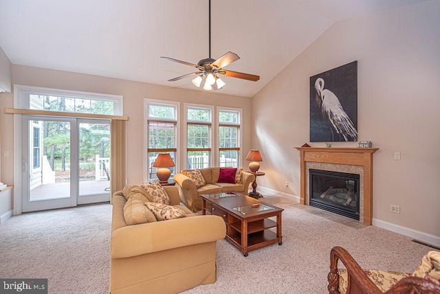 living area with a fireplace with flush hearth, carpet, vaulted ceiling, and baseboards