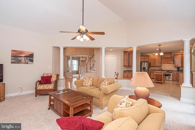 living room with light carpet, decorative columns, stairs, and baseboards