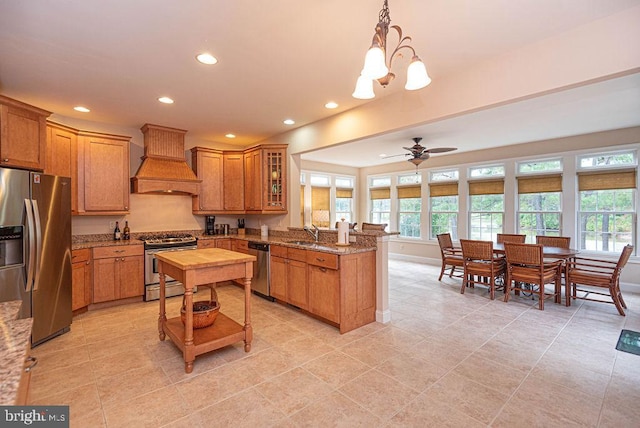 kitchen featuring stainless steel appliances, brown cabinetry, a peninsula, and custom exhaust hood