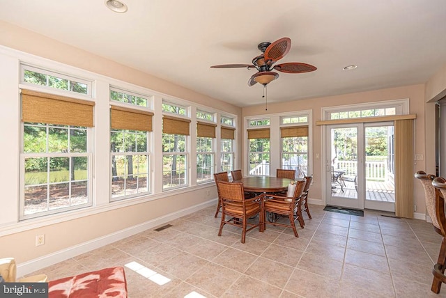 sunroom / solarium featuring visible vents, a wealth of natural light, and a ceiling fan