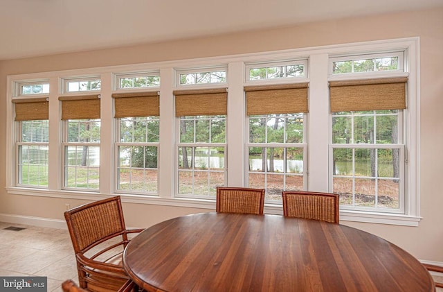 tiled dining area featuring visible vents and baseboards