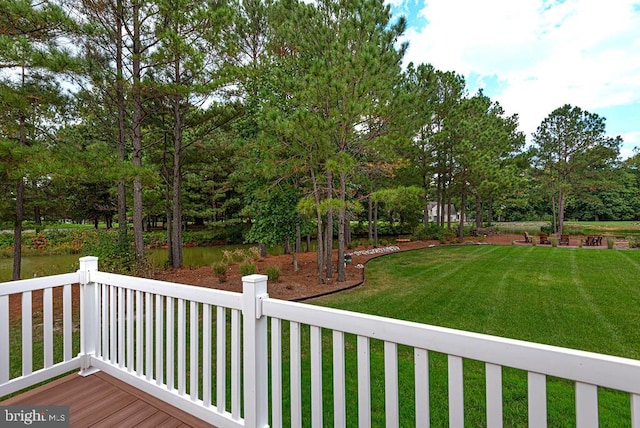 wooden terrace with a lawn