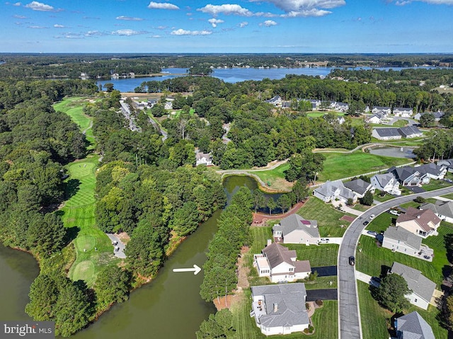 birds eye view of property featuring a residential view, view of golf course, a water view, and a forest view