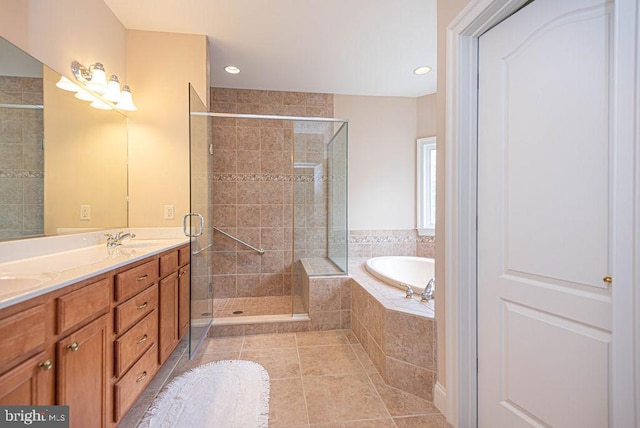 bathroom featuring double vanity, a stall shower, tile patterned flooring, and a garden tub