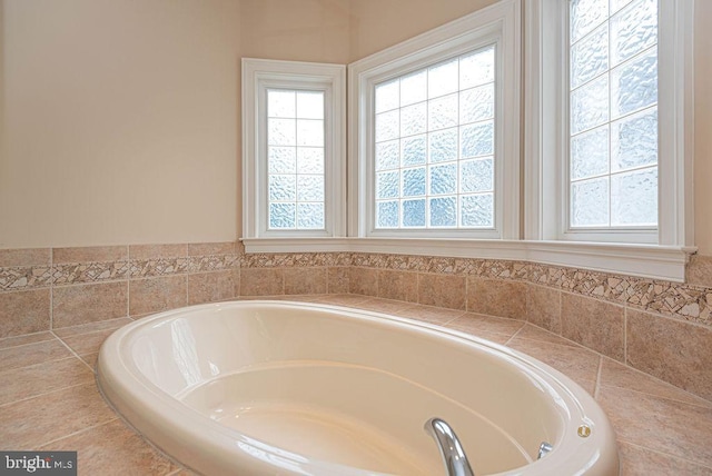 full bathroom with a wealth of natural light and a bath