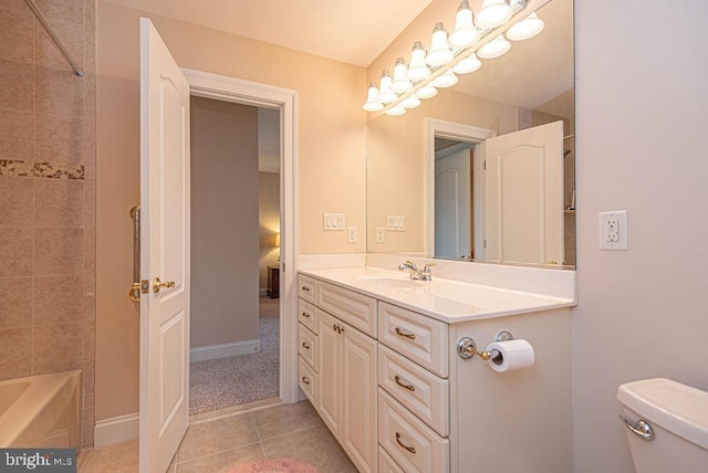 full bathroom featuring bathing tub / shower combination, toilet, vanity, baseboards, and tile patterned floors