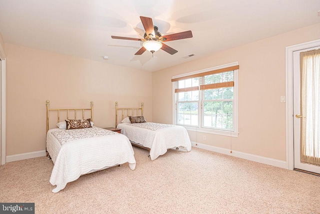 carpeted bedroom with a ceiling fan, visible vents, and baseboards