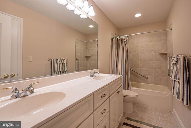 bathroom with double vanity, tile patterned flooring, shower / bath combo with shower curtain, and a sink