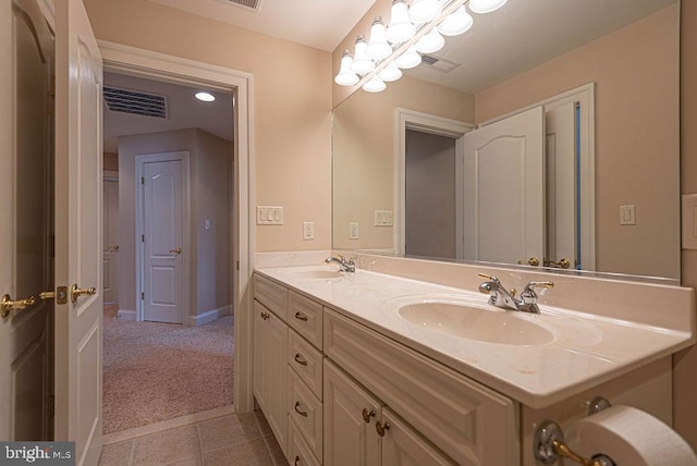 full bath featuring tile patterned floors, visible vents, a sink, and double vanity