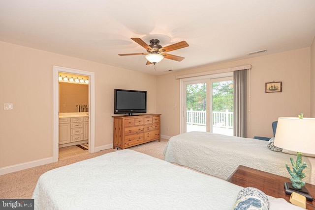 bedroom featuring light carpet, visible vents, baseboards, access to outside, and ensuite bath