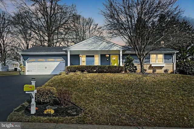 ranch-style home featuring brick siding, a garage, and driveway