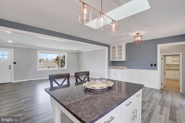 kitchen featuring glass insert cabinets, open floor plan, dark wood-style floors, and white cabinets