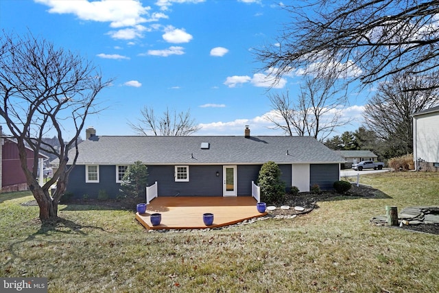 rear view of property with a lawn, a deck, and a chimney