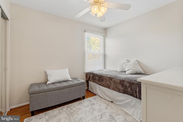 bedroom with baseboards, a ceiling fan, and wood finished floors