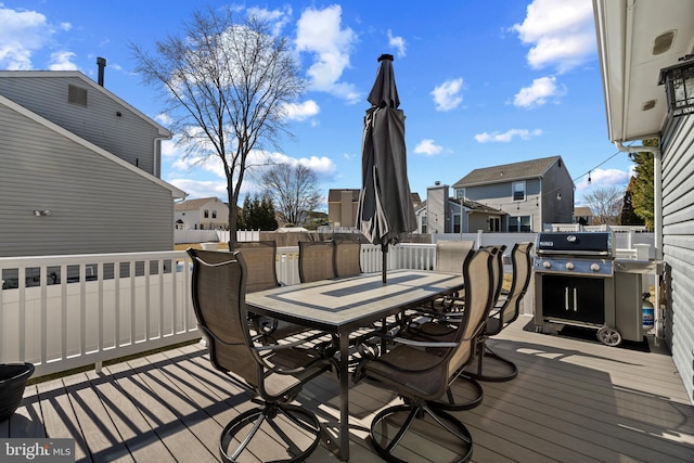 wooden deck featuring a fenced backyard, a residential view, and outdoor dining area