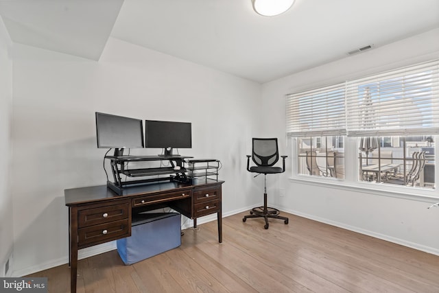 office featuring visible vents, baseboards, and wood finished floors