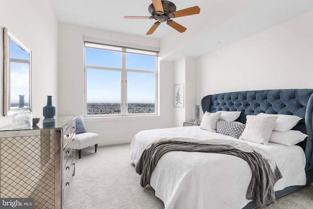 bedroom with a ceiling fan, carpet flooring, and baseboards