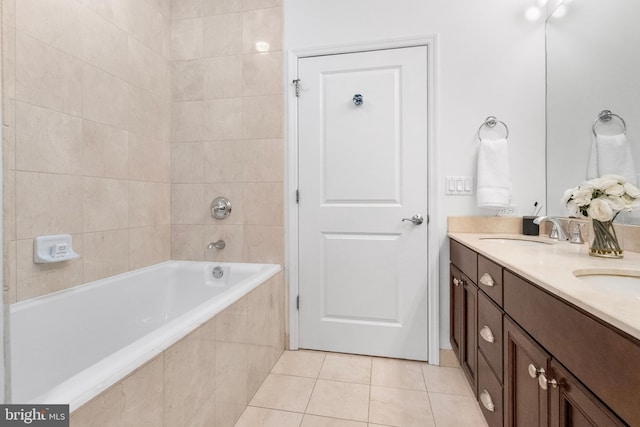 full bathroom with double vanity, a sink, and tile patterned floors