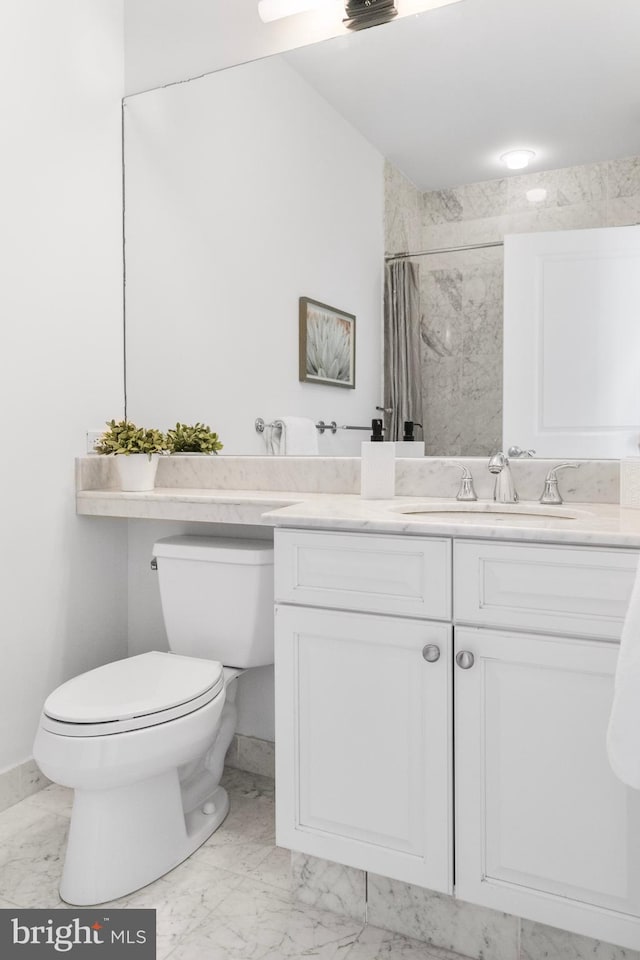 bathroom featuring toilet, marble finish floor, a shower with curtain, and vanity