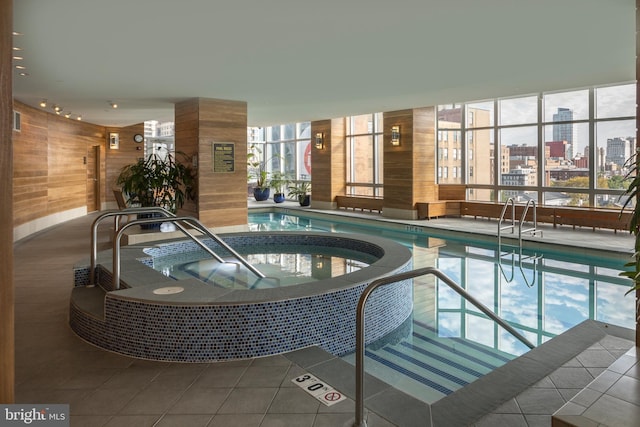 pool with an indoor hot tub and a city view