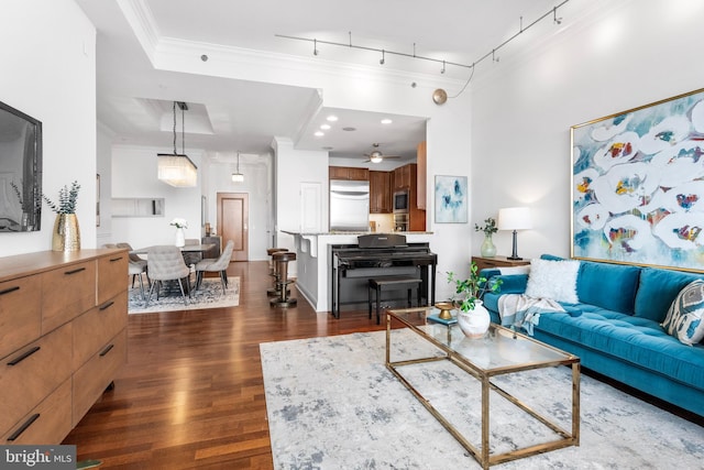 living room featuring dark wood-style floors, recessed lighting, rail lighting, and crown molding