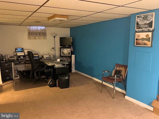 office space featuring a drop ceiling, carpet, and baseboards