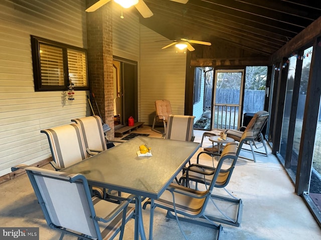 sunroom with a ceiling fan and lofted ceiling