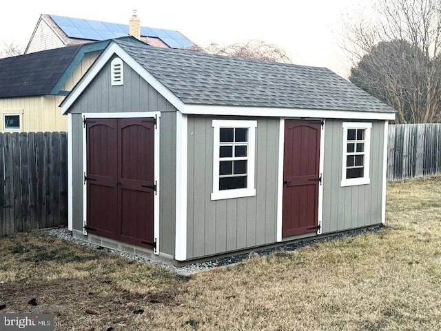 view of shed with fence