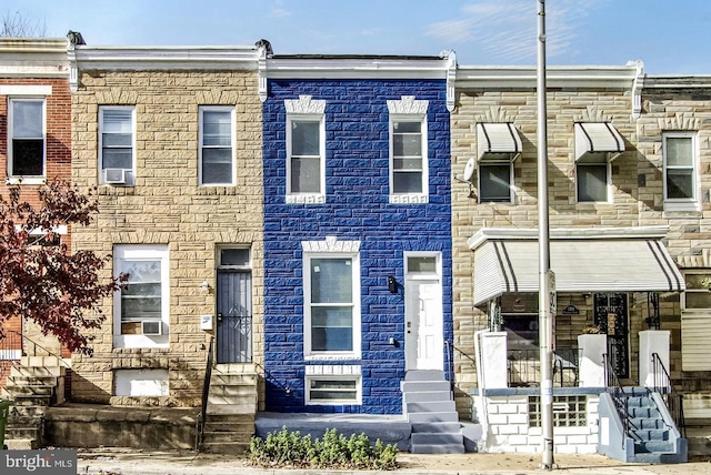 multi unit property with stone siding and cooling unit